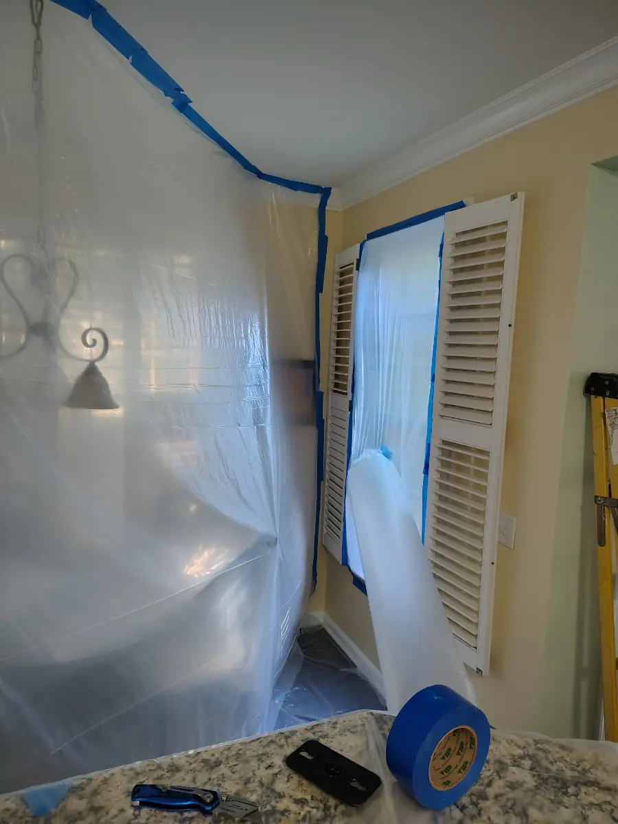 Protective sheeting installed over damaged windows during a storm response