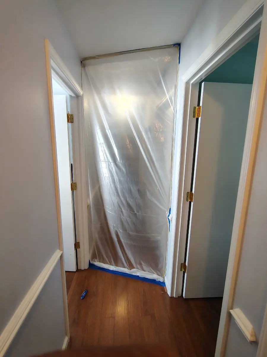 Containment sheeting sealed across a doorway during an OCI Restoration mold remediation