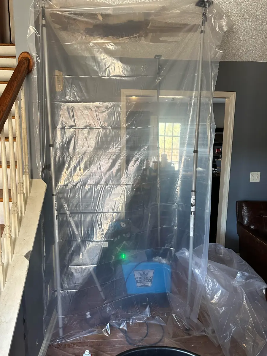 Protective sheeting and drying equipment staged during fire damage restoration