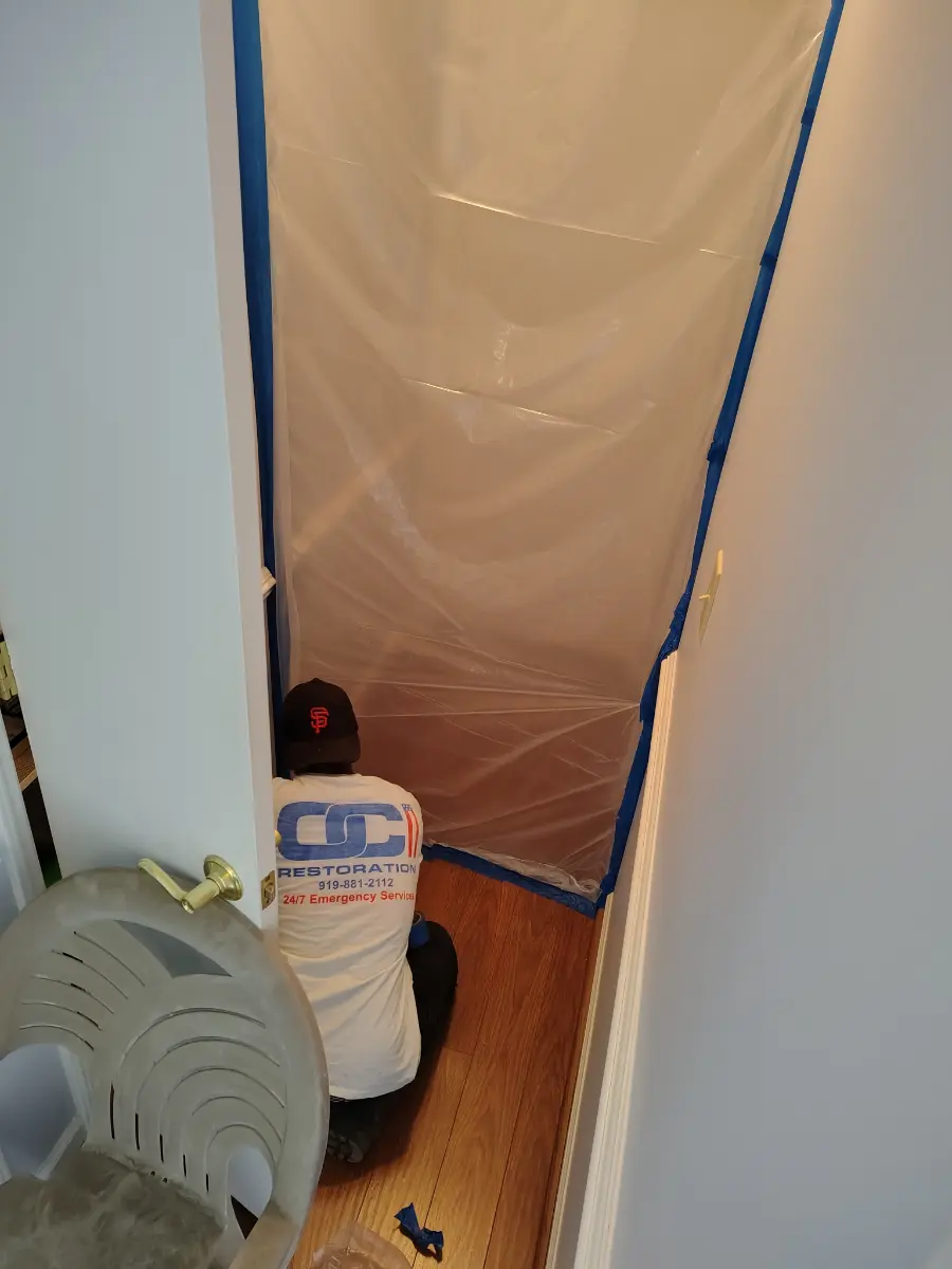 OCI Restoration technician performing cleanup at a fire-damaged property