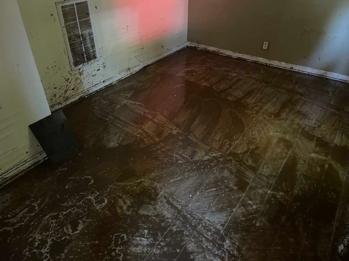 Storm water intrusion across a ground floor, documented before drying
