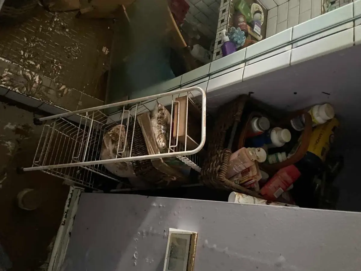 Water-damaged interior shelving documented before drying